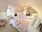 Upper level pink bedroom with two twin beds